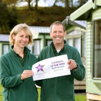Helen & Jon Hill holding a 'Campsite of the Year' award