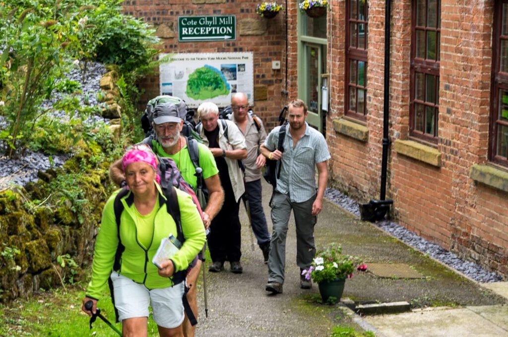 group of walkers exiting Cote Ghyll Mill