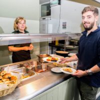 guests loading plates at buffet style breakfast