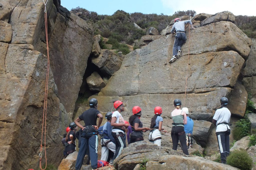 Group of teenagers rock climbing