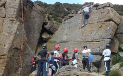 Group of teenagers rock climbing