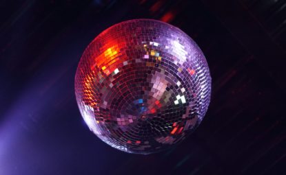 Glittering disco ball hanging from ceiling