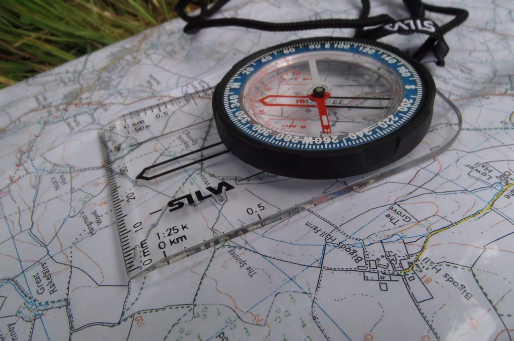 A compass resting on a map