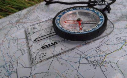 A compass resting on a map